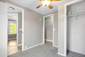 Unfurnished bedroom featuring a closet, ceiling fan, and wood-type flooring