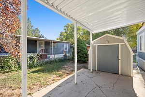 View of patio featuring a shed