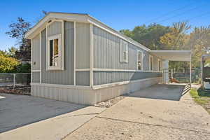 View of side of property with a carport