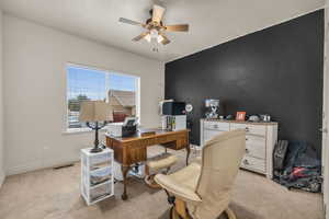 Carpeted home office with ceiling fan