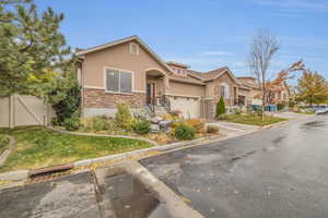 View of front of property featuring a front yard and a garage