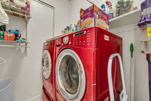 Clothes washing area featuring washer and dryer