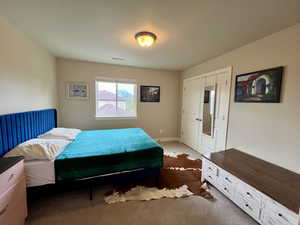 Bedroom featuring dark colored carpet