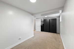 Unfurnished room featuring light colored carpet