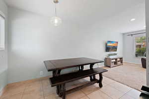 Dining area featuring light colored carpet