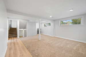 Basement with light hardwood / wood-style flooring