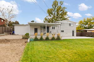 Rear view of property featuring a patio area and a lawn