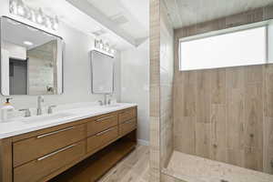 Bathroom featuring vanity and a shower