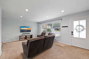 Living room featuring light carpet