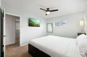 Bedroom with light colored carpet and ceiling fan