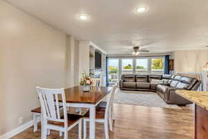 Dining area featuring a textured ceiling, light hardwood / wood-style floors, and ceiling fan