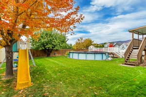 View of yard with a pool side deck