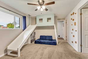 Carpeted bedroom with ceiling fan