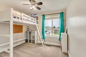 Carpeted bedroom with ceiling fan