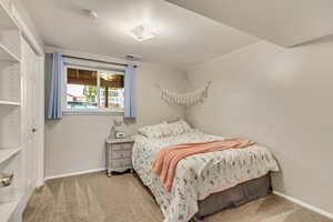 Carpeted bedroom with a closet