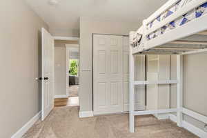 Unfurnished bedroom featuring carpet flooring and a closet