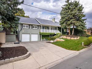 View of front of house with a porch and a garage