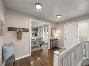 Foyer entrance with wood-type flooring