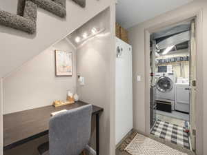 Washroom featuring independent washer and dryer