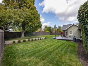 View of yard with a trex deck and covered back patio