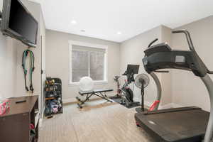 4th bedroom and workout area with light colored carpet