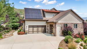 View of front facade featuring solar panels