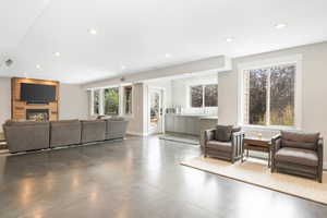 Living room with concrete flooring and a fireplace