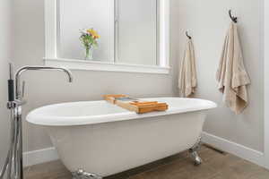 Bathroom with a bath and tile patterned flooring