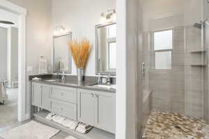 Bathroom with vanity and a shower with door