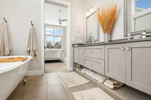 Bathroom featuring vanity, a bathing tub, hardwood / wood-style flooring, and ceiling fan