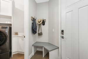 Laundry room with washer / dryer, cabinets, and light tile patterned floors