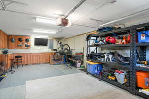 Utility garage featuring a workshop area with entrance to basement level.