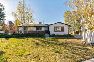 Ranch-style home with a front lawn