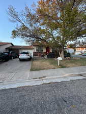 View of front of property with a front lawn and a garage