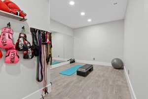 Exercise room with light wood-type flooring