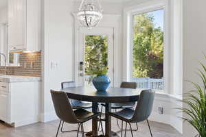 Dining area featuring an inviting chandelier and light hardwood / wood-style floors