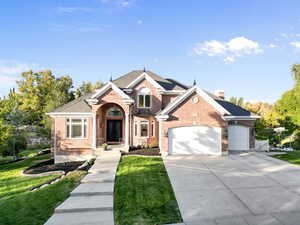 View of front of house with a front lawn and a garage