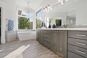 Bathroom with vanity, hardwood / wood-style floors, separate shower and tub, and ornamental molding