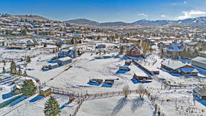 Snowy aerial view featuring a mountain view