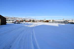 Yard layered in snow with a mountain view