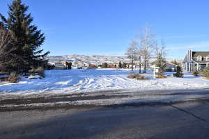 Snowy yard featuring a mountain view