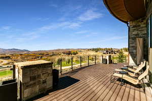 Wooden terrace featuring a mountain view