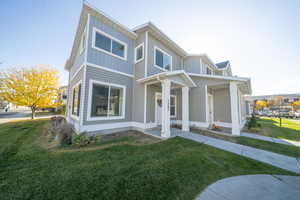 View of front of property featuring a front lawn and a porch