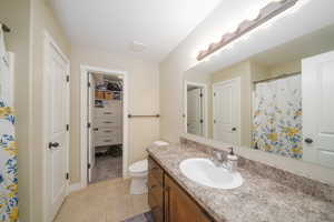 Primary bathroom with vanity, toilet, and tile patterned floors