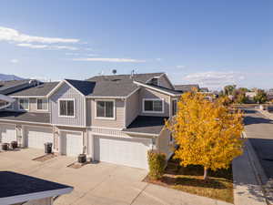 Townhome / multi-family property featuring a garage