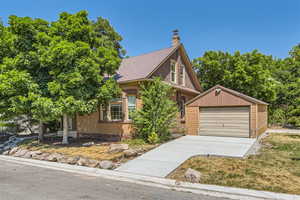 View of front of house with an outbuilding and a garage