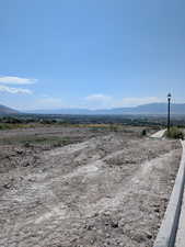 View of mountain backdrop featuring rural landscape