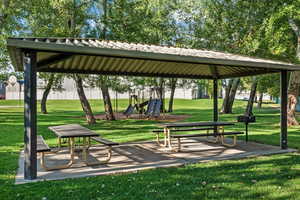 View of home's community with a yard and a playground