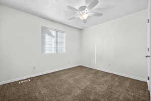 Spare room with carpet floors and ceiling fan