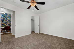 Unfurnished bedroom with carpet floors and ceiling fan